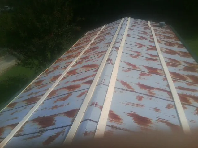 Rusted metal roof panels with new wood purlins before replacement — Storm Damage Roof Repair in Maricopa by Roofing Brothers